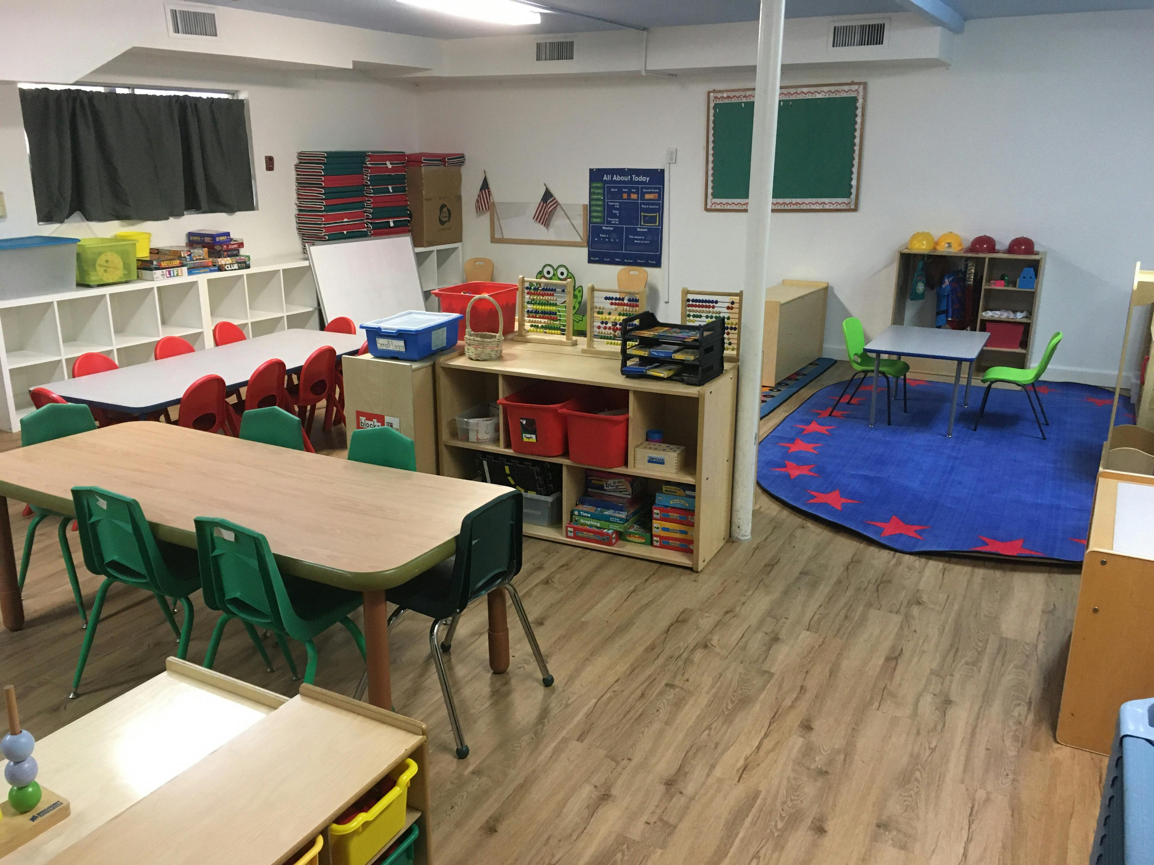 Classroom with tables, chairs, and storage shelves