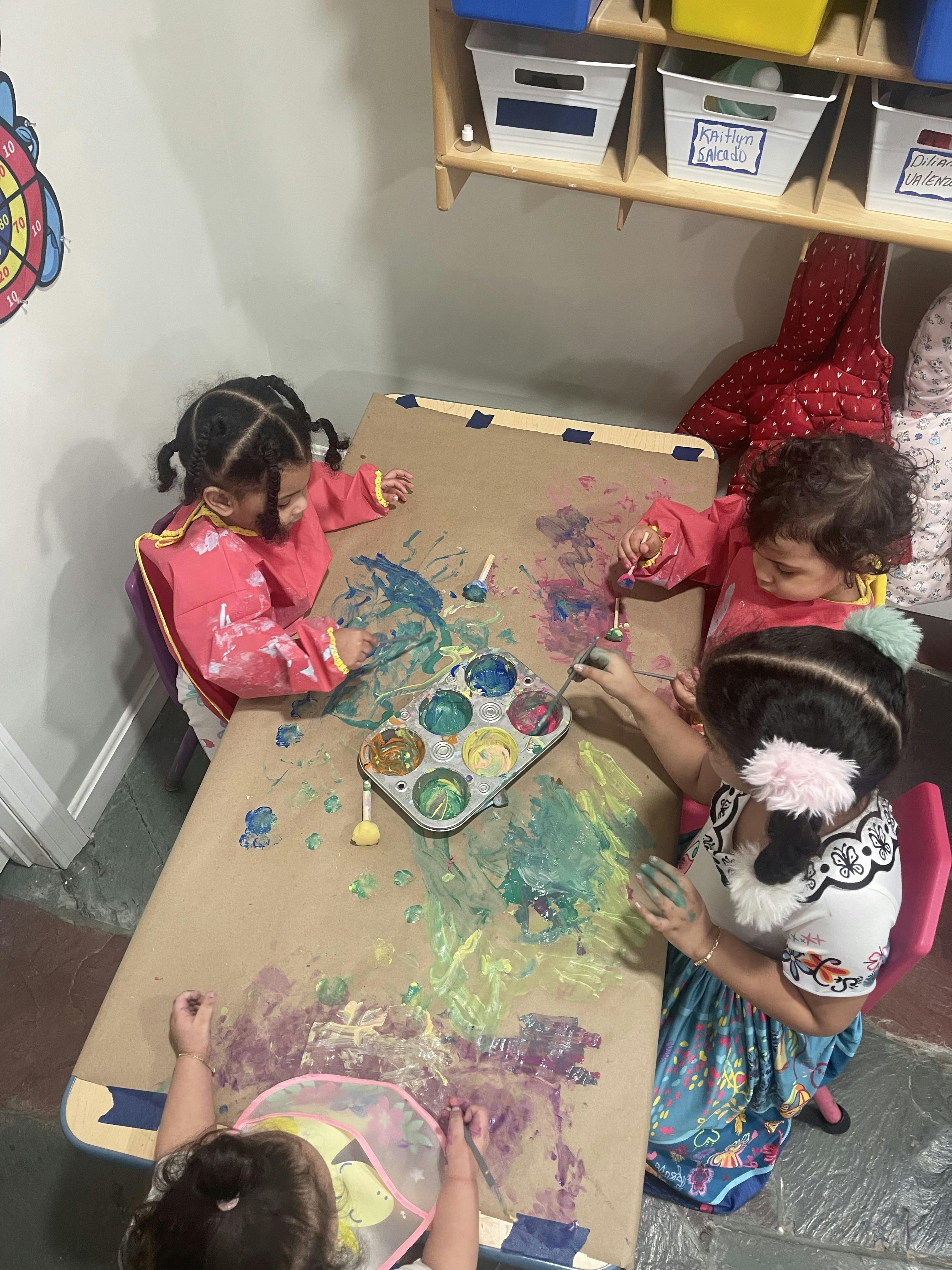 Children painting at a table