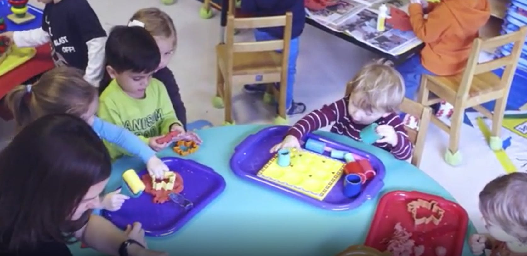 Children at a table playing with art supplies