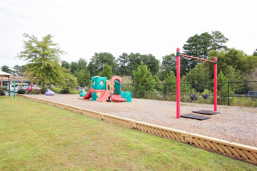 Playground with colorful play structure and swings