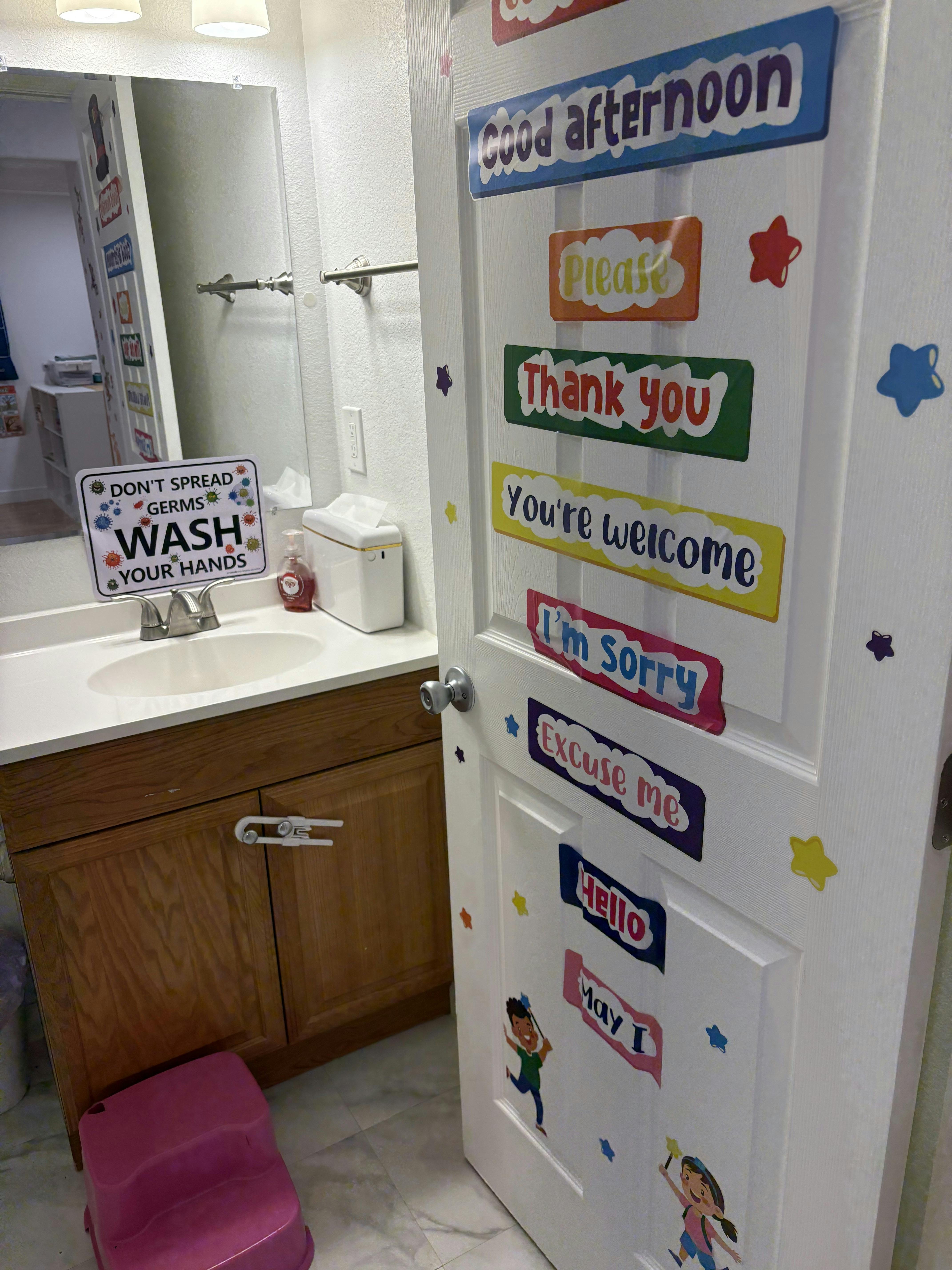 Bathroom door with educational signs and hand washing instructions