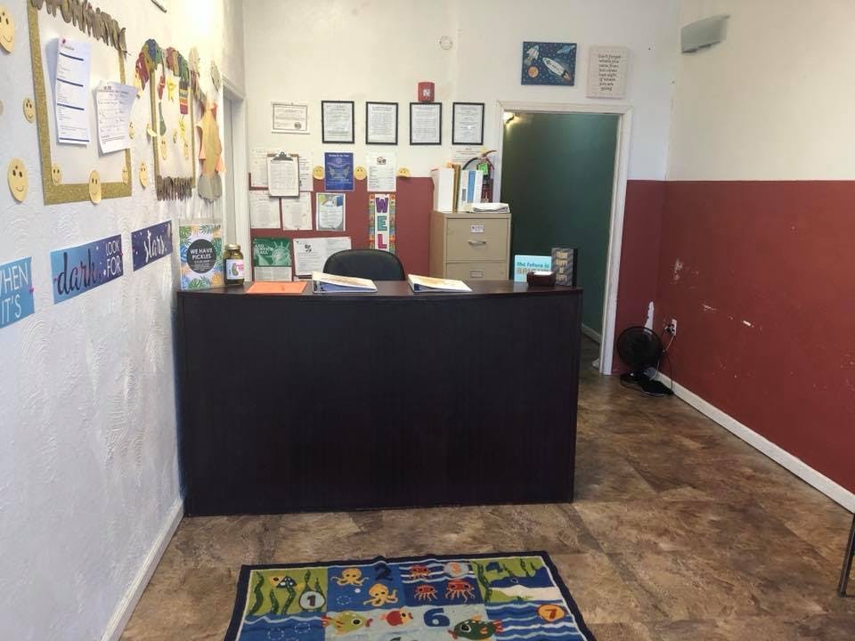 Reception desk in a room with a colorful rug