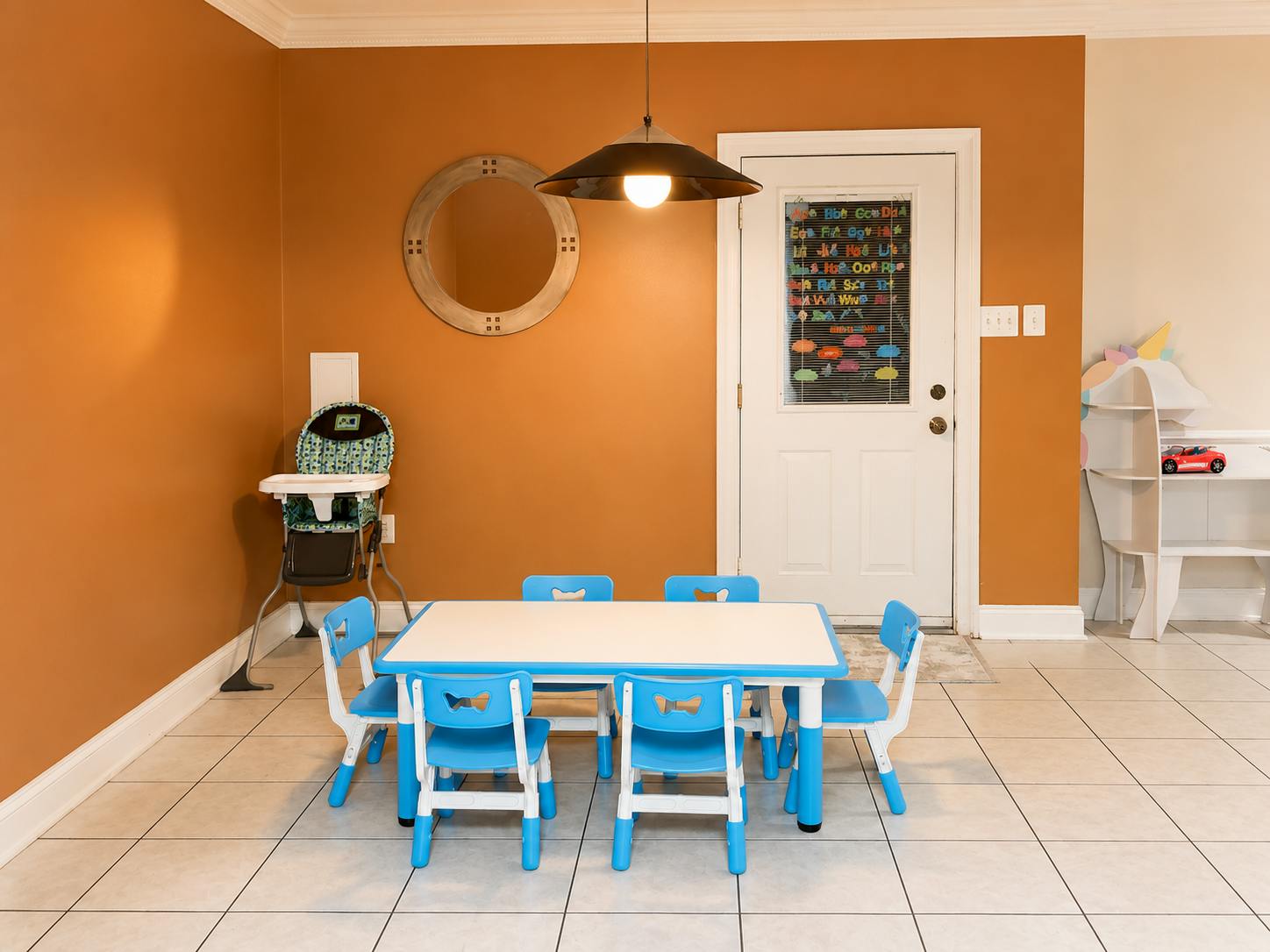 Small table and four chairs for children in a room