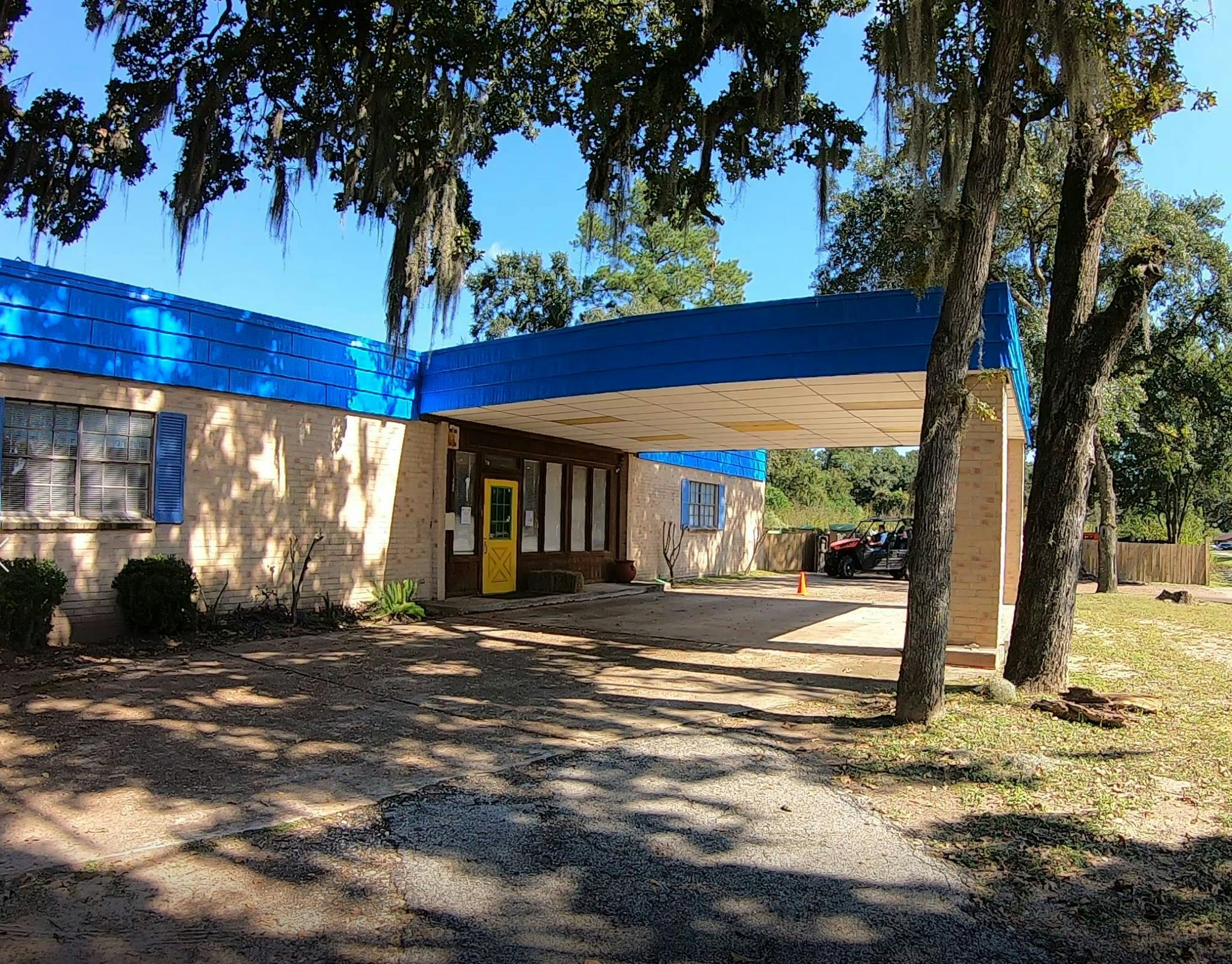 Building with blue roof and yellow door