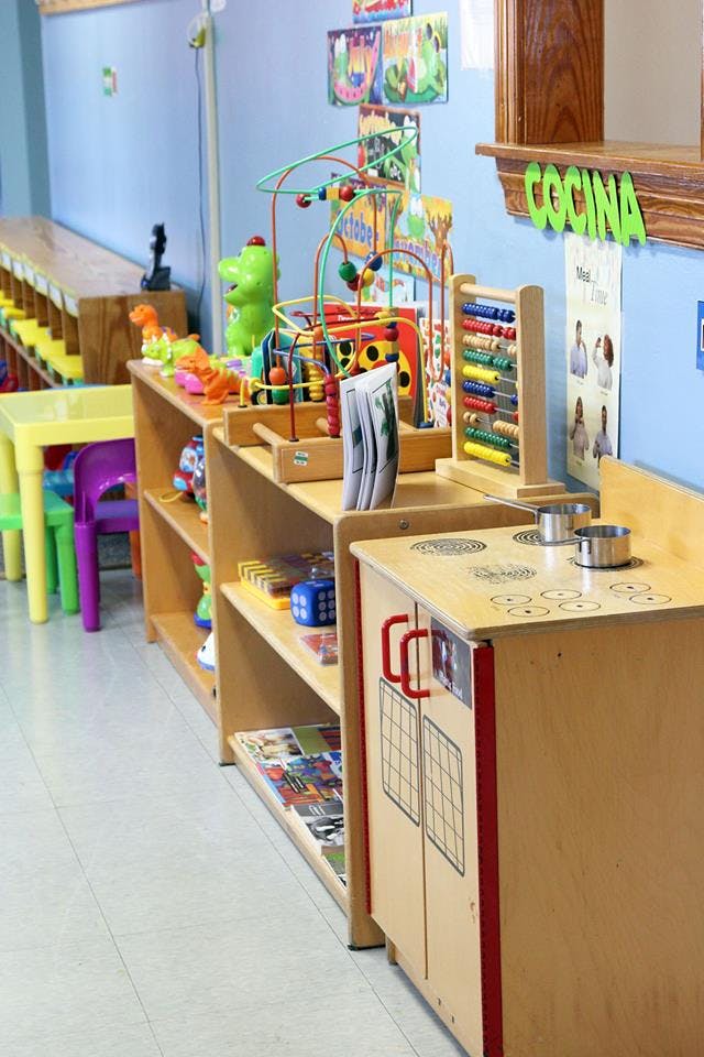 Play kitchen and shelves with toys in a classroom