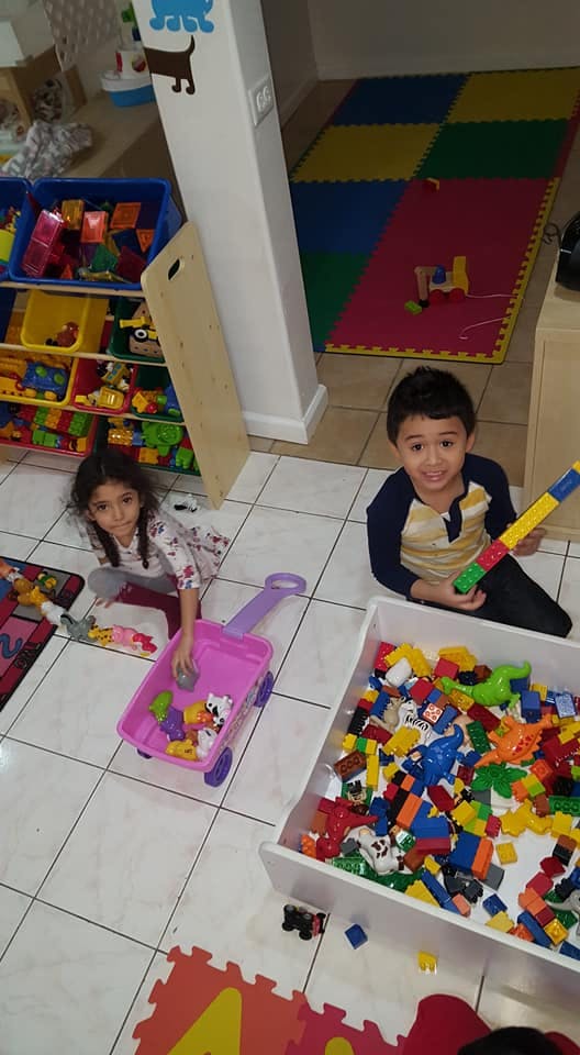 Two children playing with toys in a room