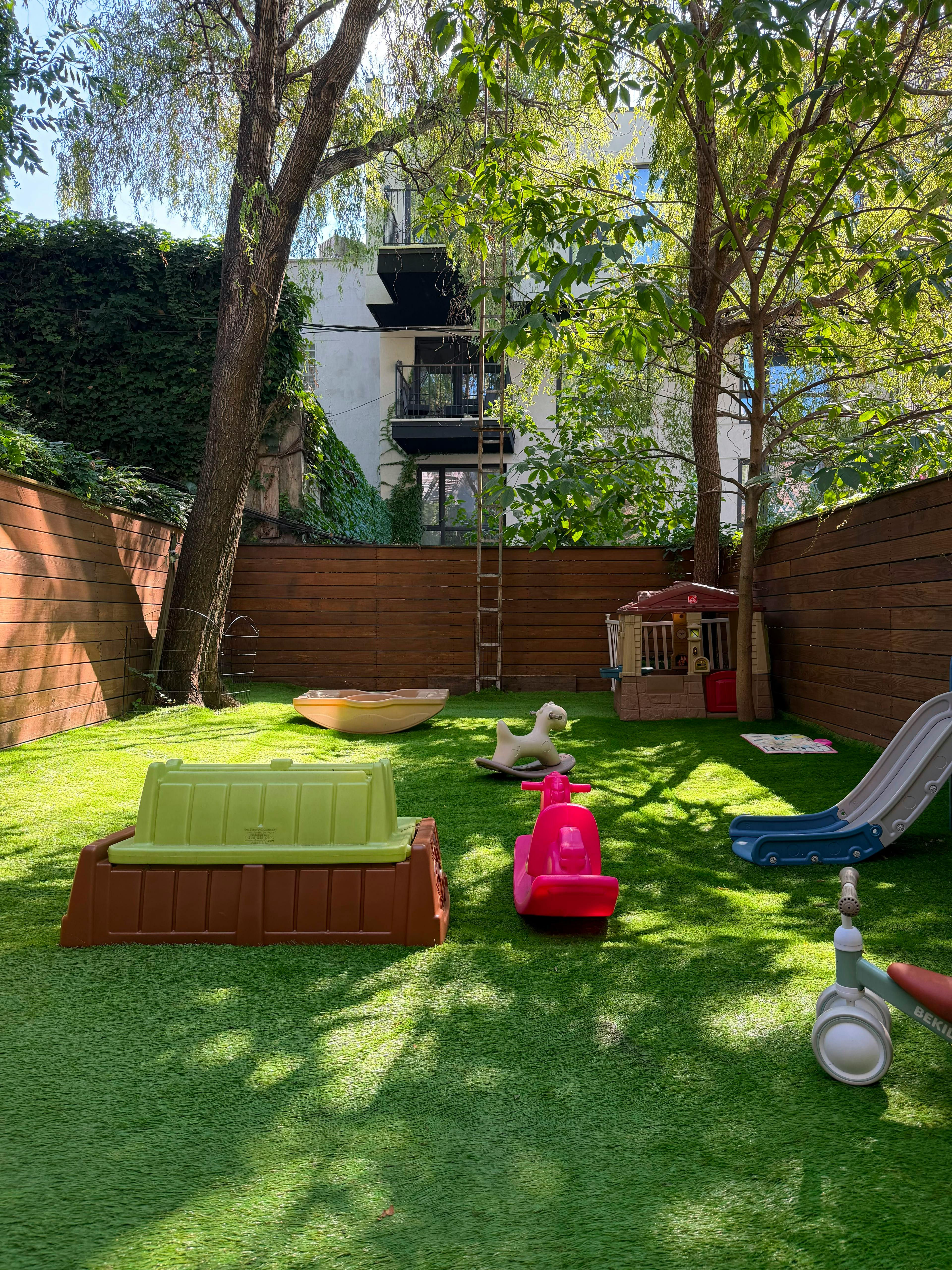 Plastic playground equipment on a backyard lawn