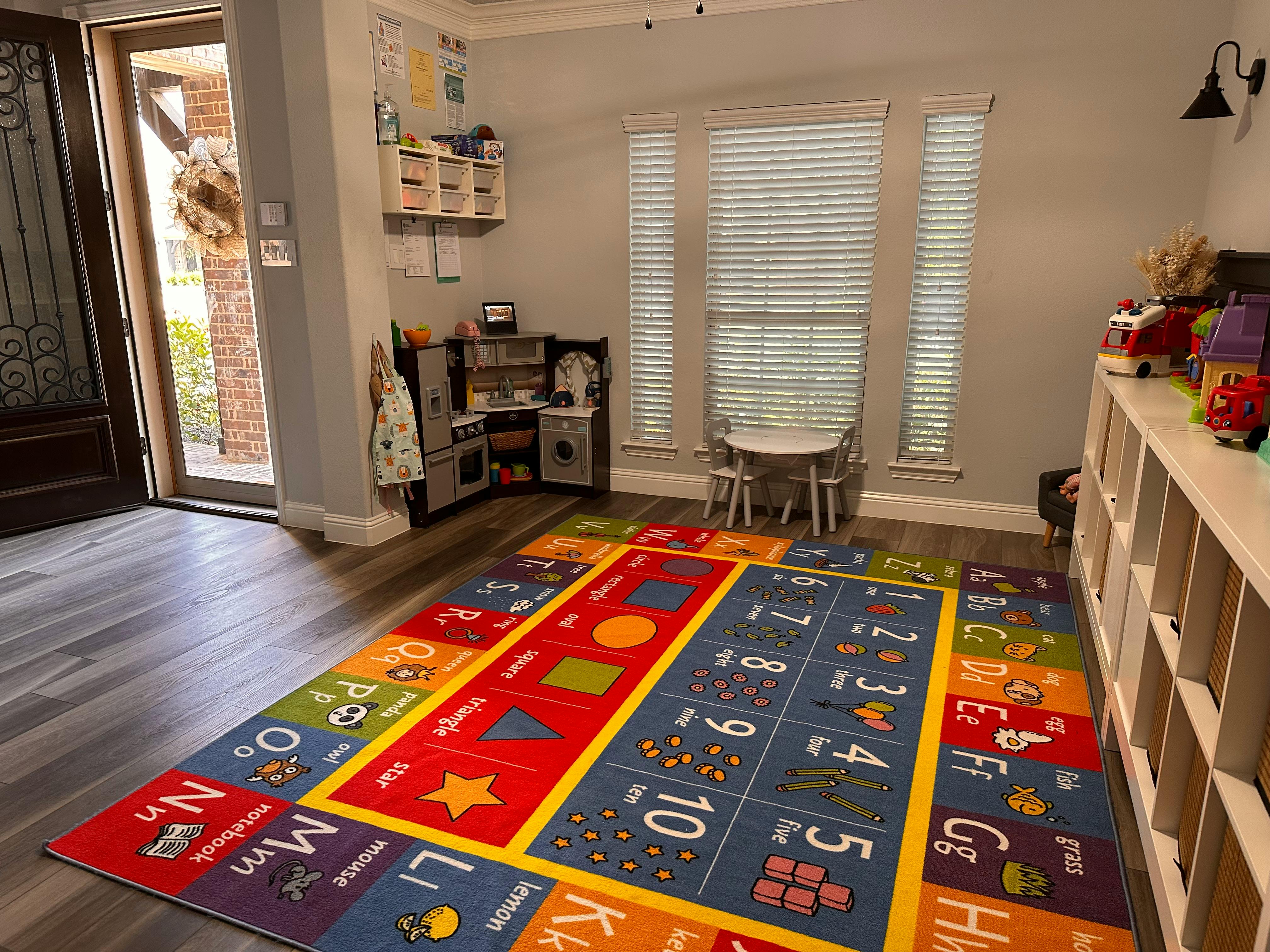 Playroom with a colorful alphabet and numbers rug