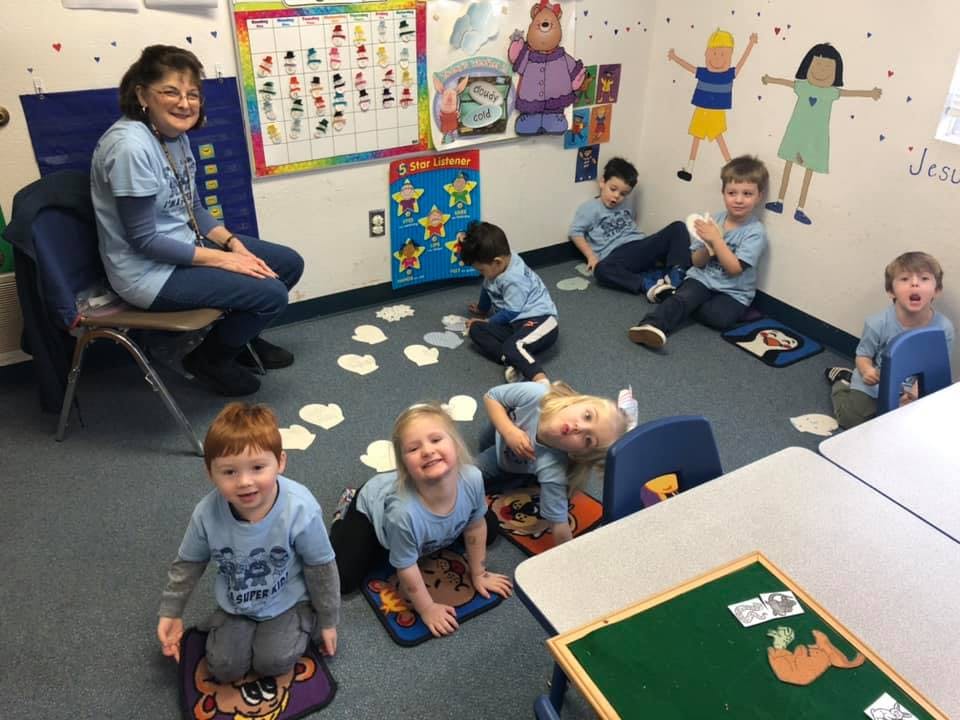 Adult and children in a classroom
