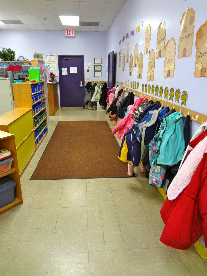 Coats hanging on hooks in a classroom hallway