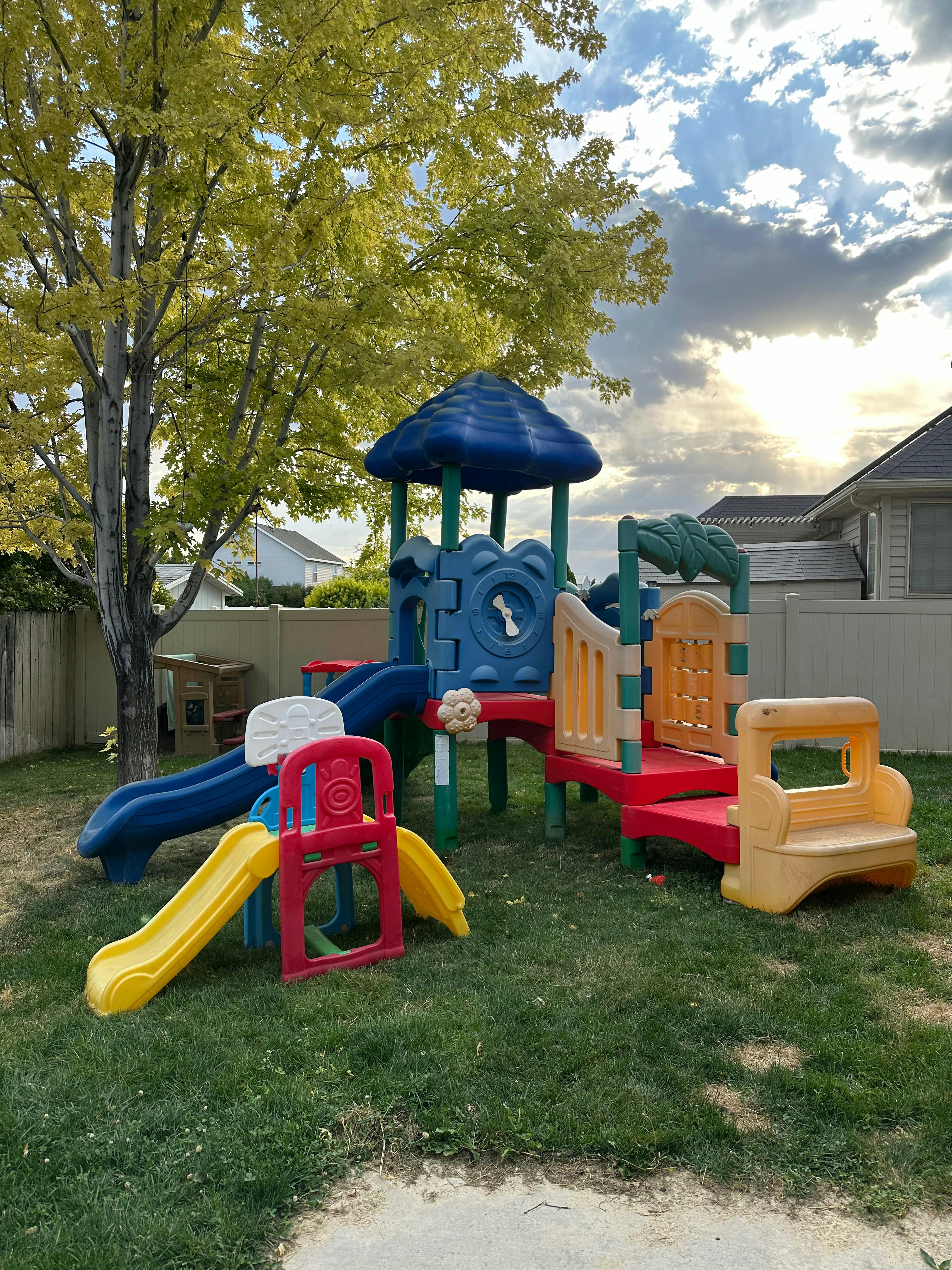Colorful backyard playground set with slides and climbing structures