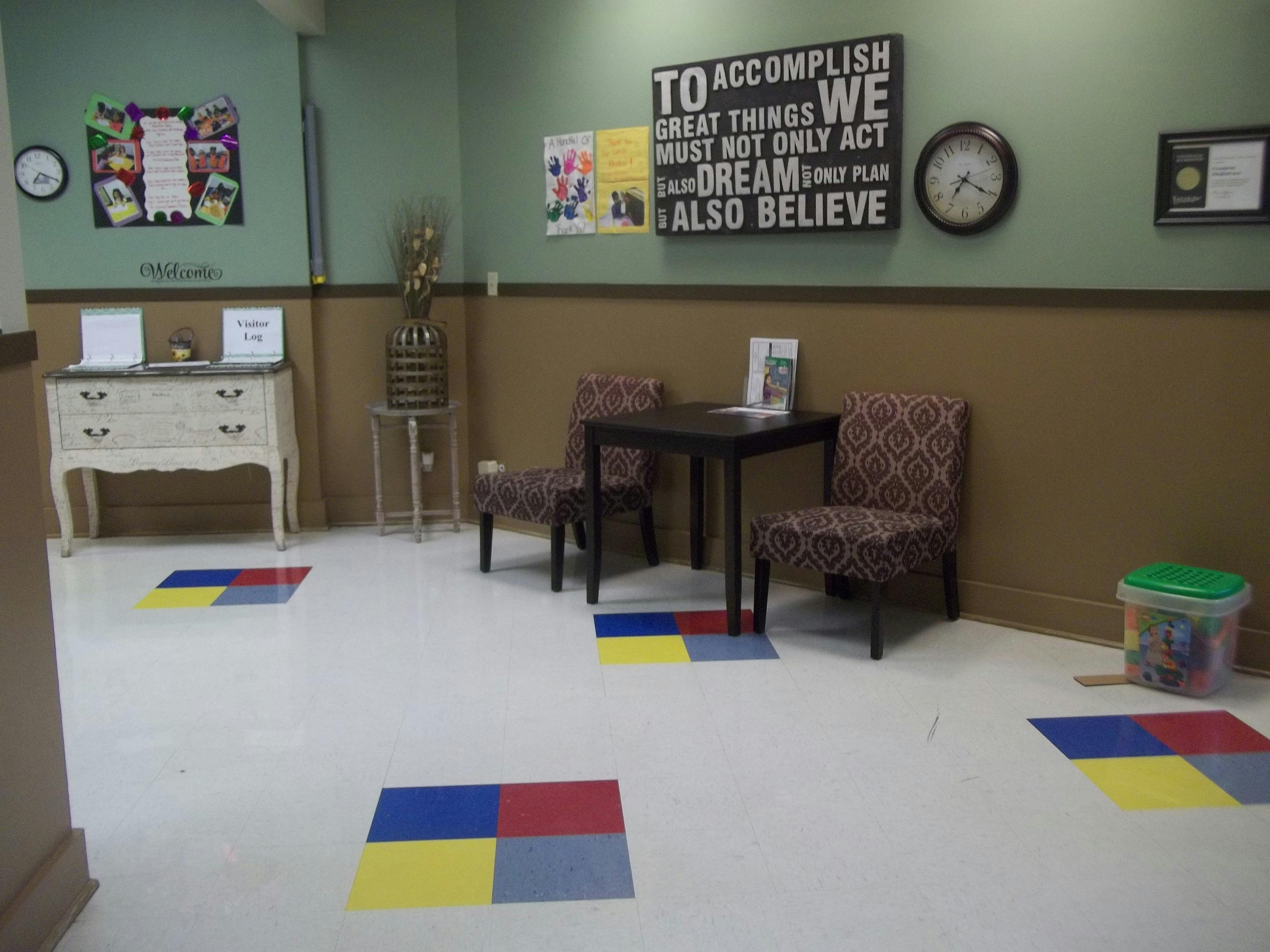Waiting room with two chairs, a table, and motivational wall art