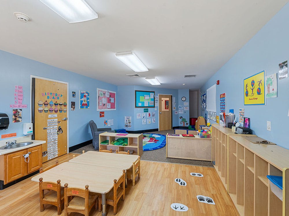 Classroom with tables, chairs, and learning materials