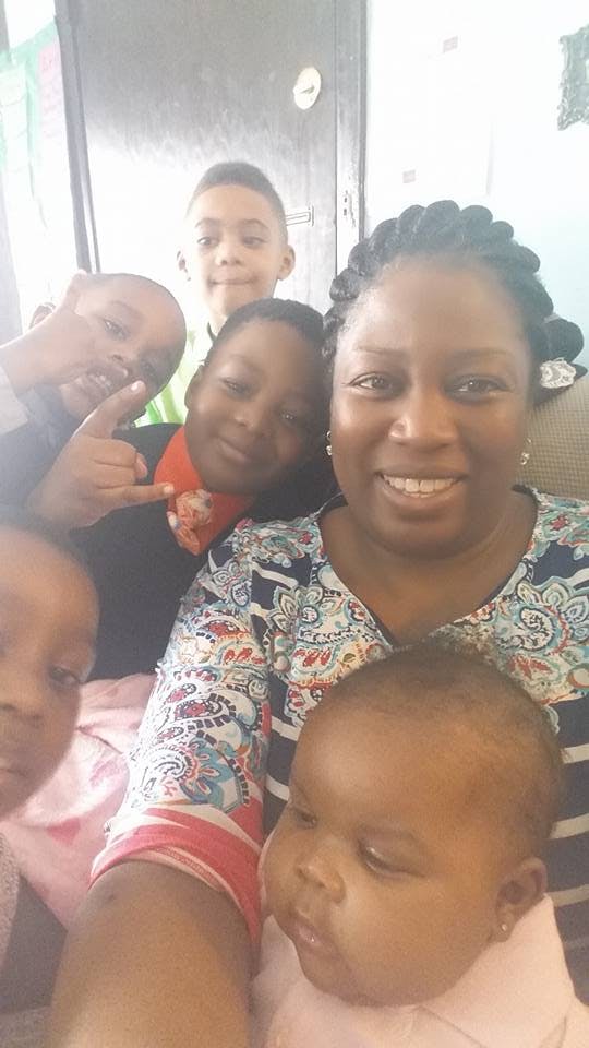 Person and multiple children posing for a photo
