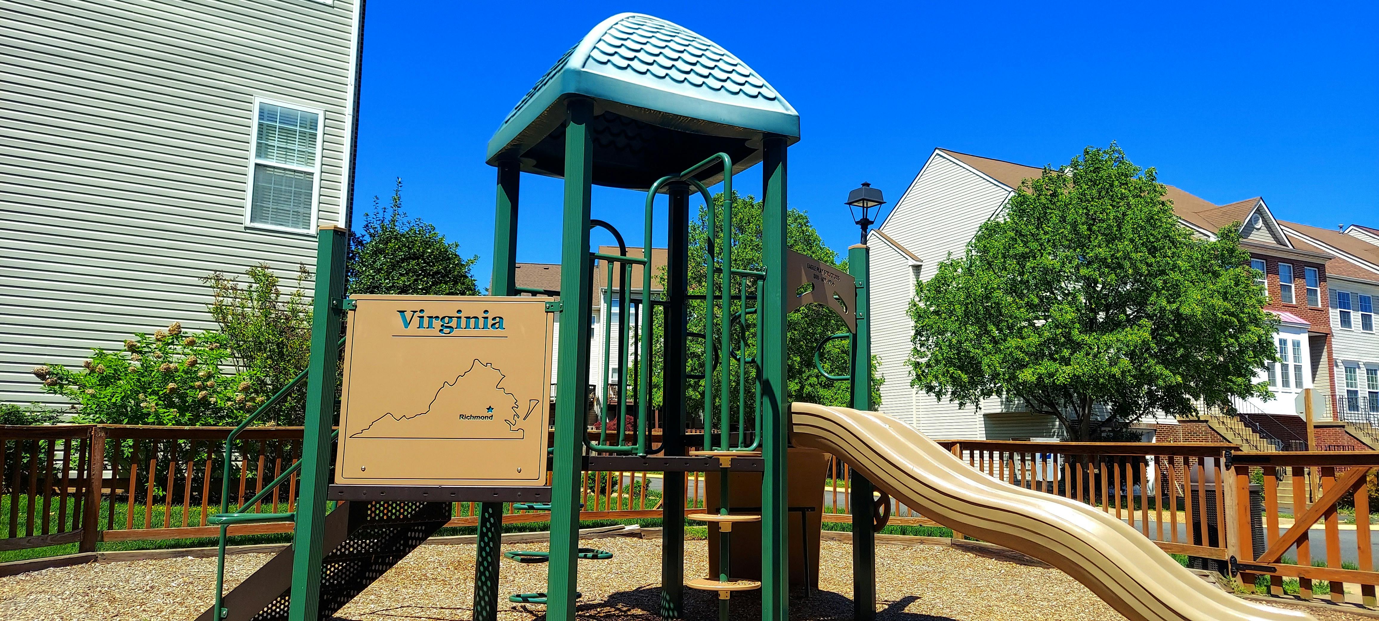 Playground structure with a slide and a sign that says "Virginia"