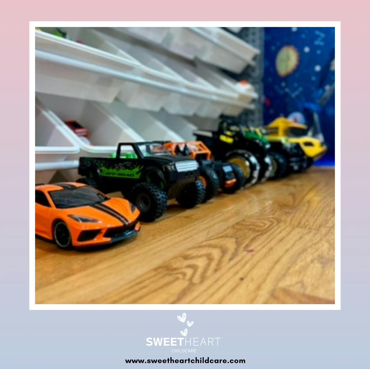 Toy cars and monster trucks lined up on a wooden surface