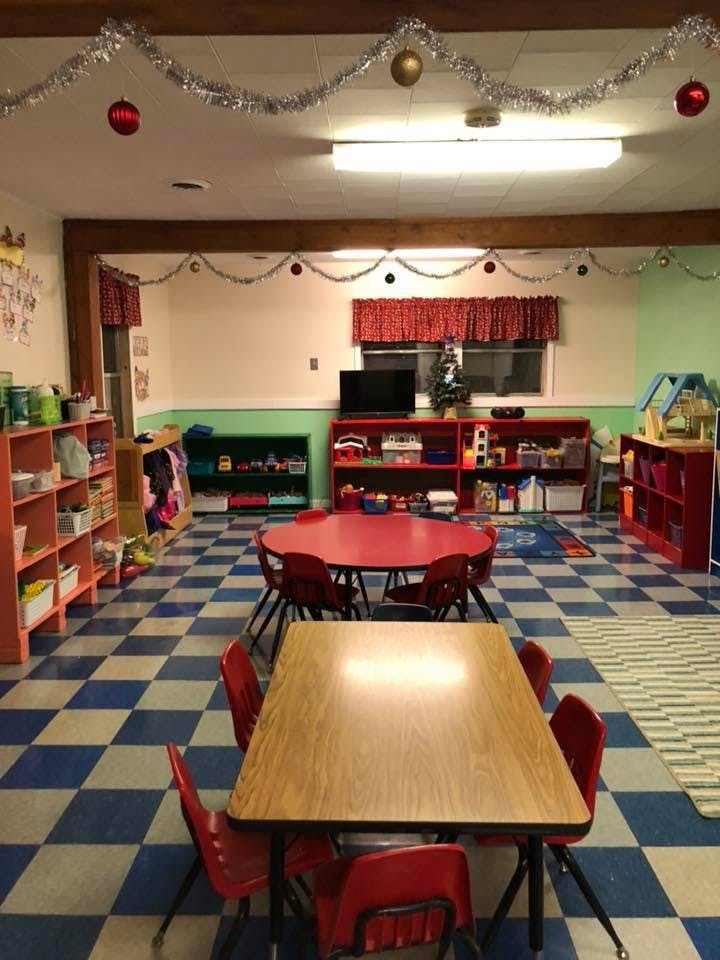 Classroom with tables and chairs, decorated with tinsel and ornaments