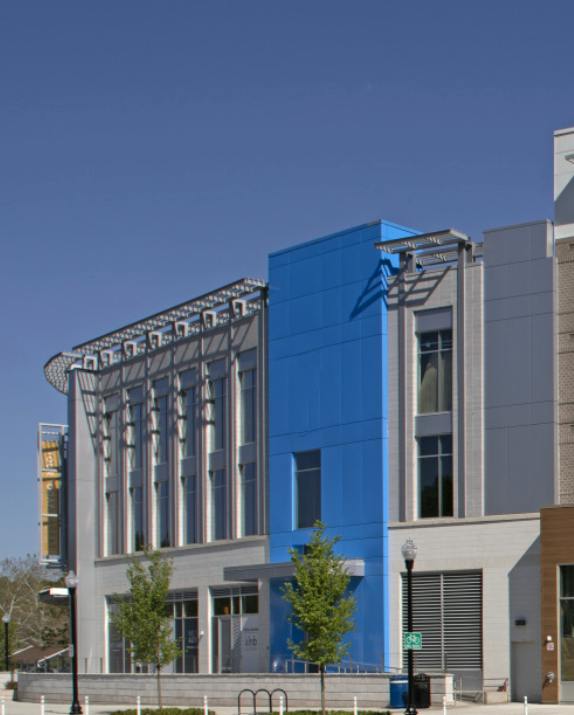Modern multi-story commercial building with a blue facade