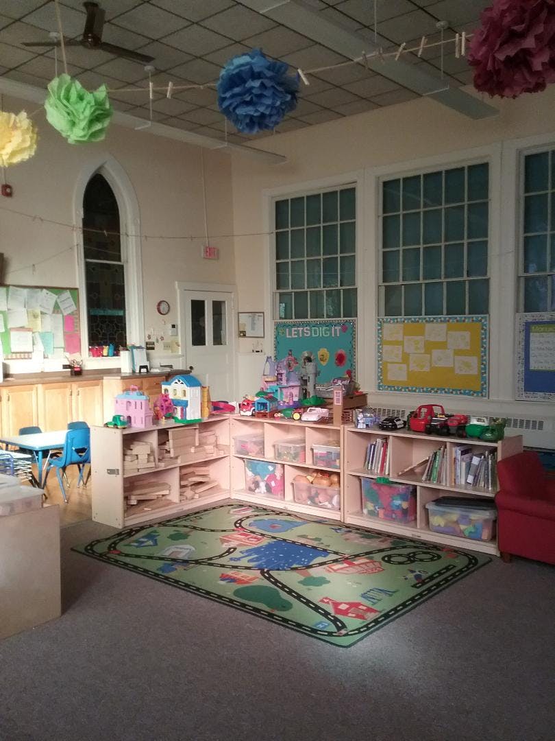 Playroom with toy shelves, a road map rug, and colorful decorations
