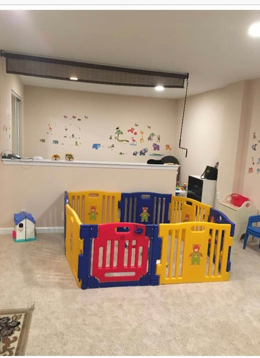 Colorful playpen in a room with wall decals