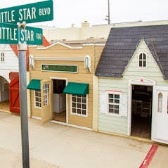 Miniature buildings with a street sign for Little Star Blvd