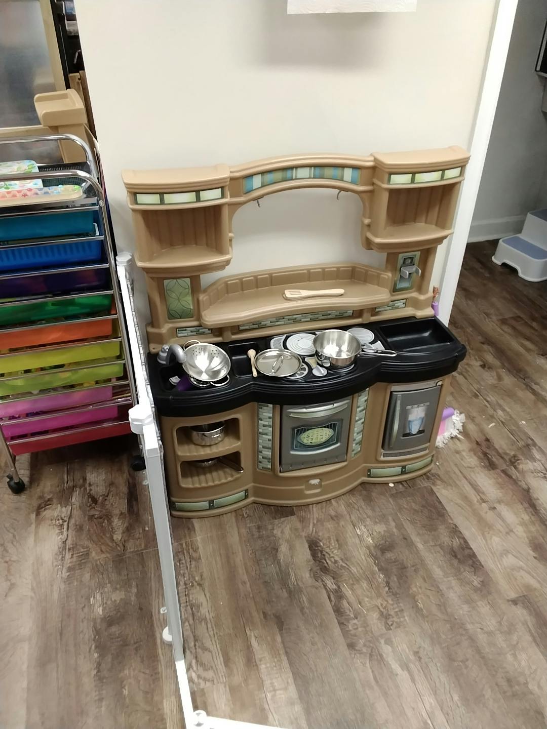 Toy kitchen with pots and pans on the counter