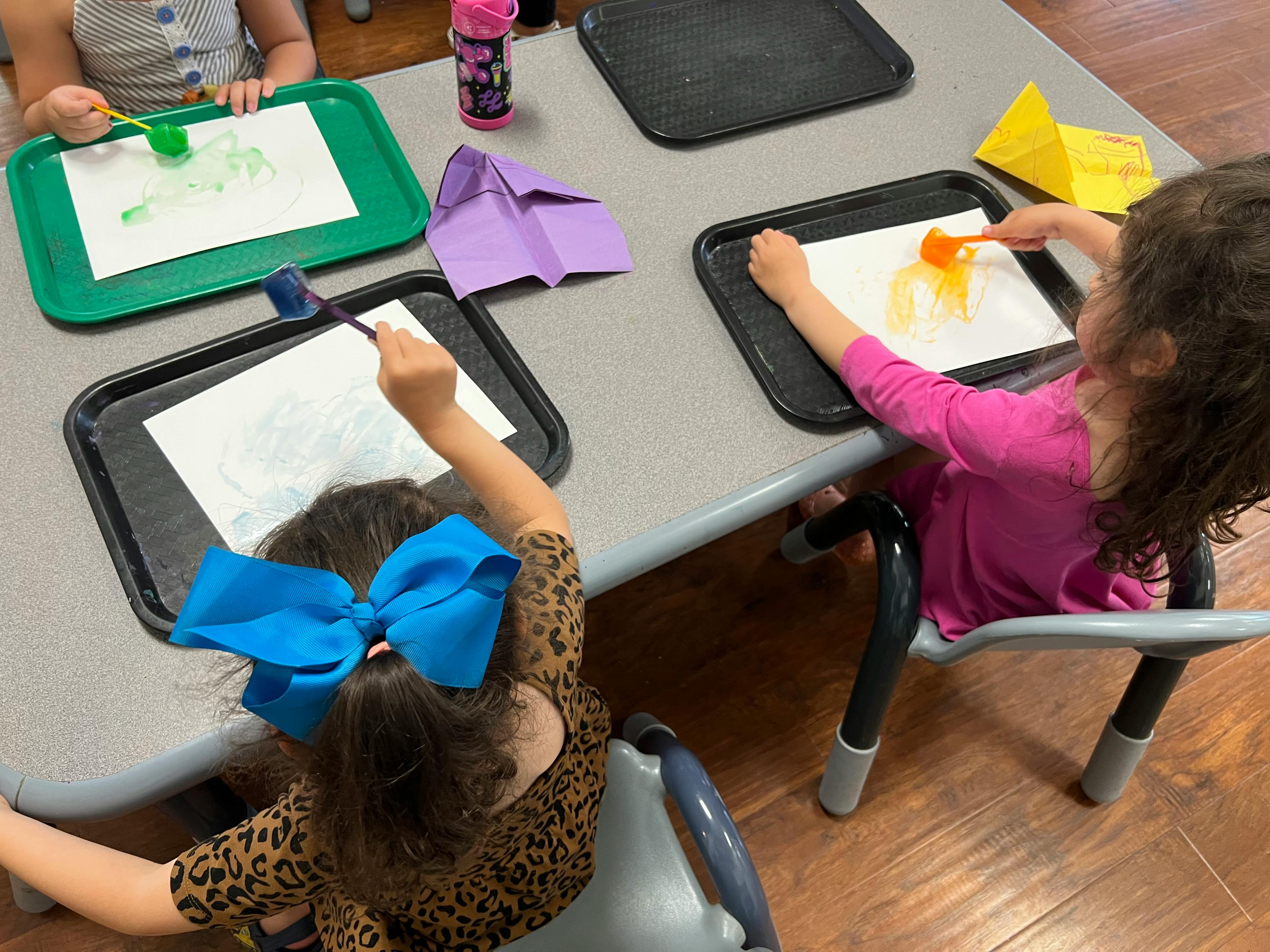 Children painting at a table