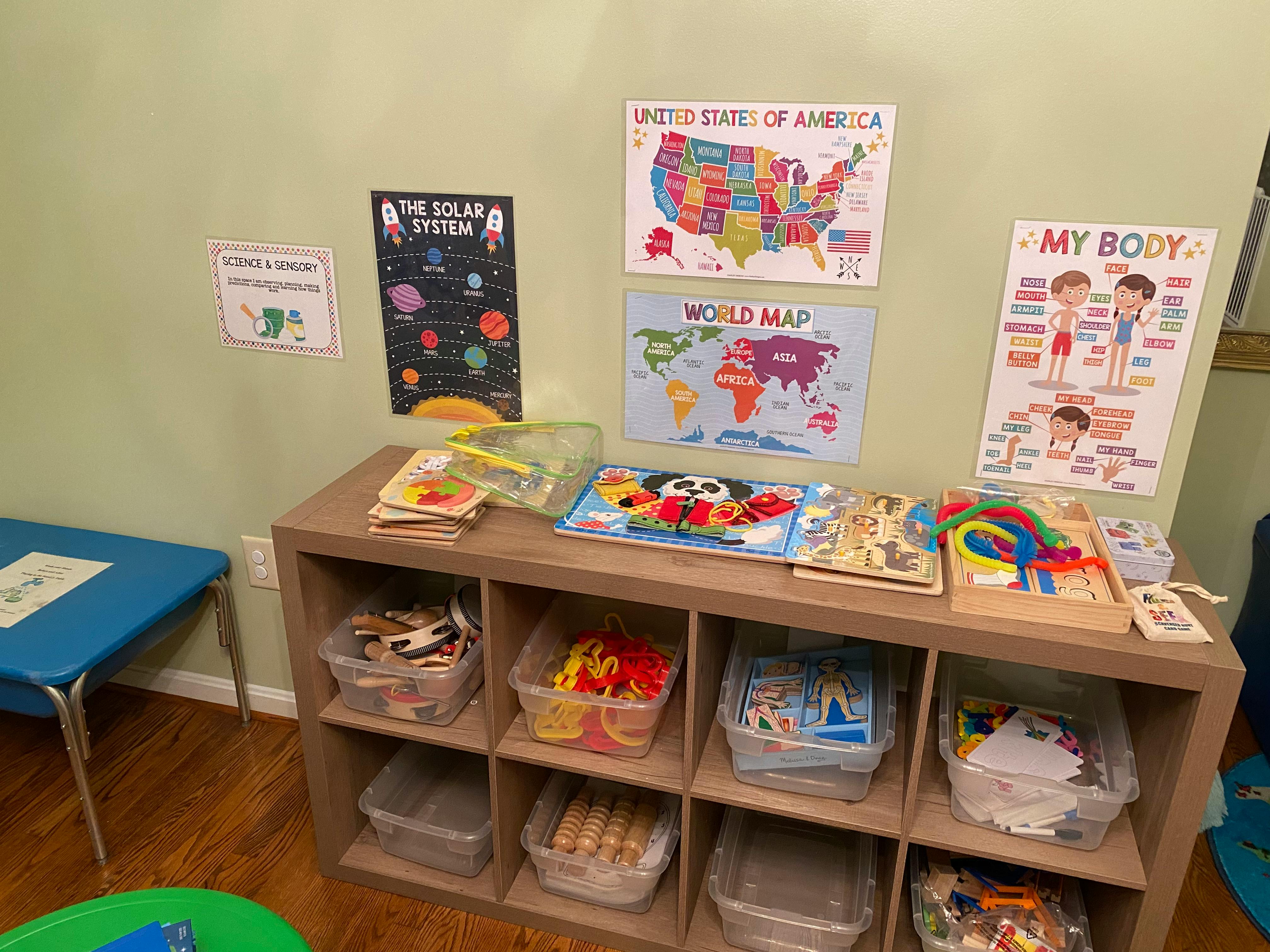 Classroom with educational posters and storage shelves with toys