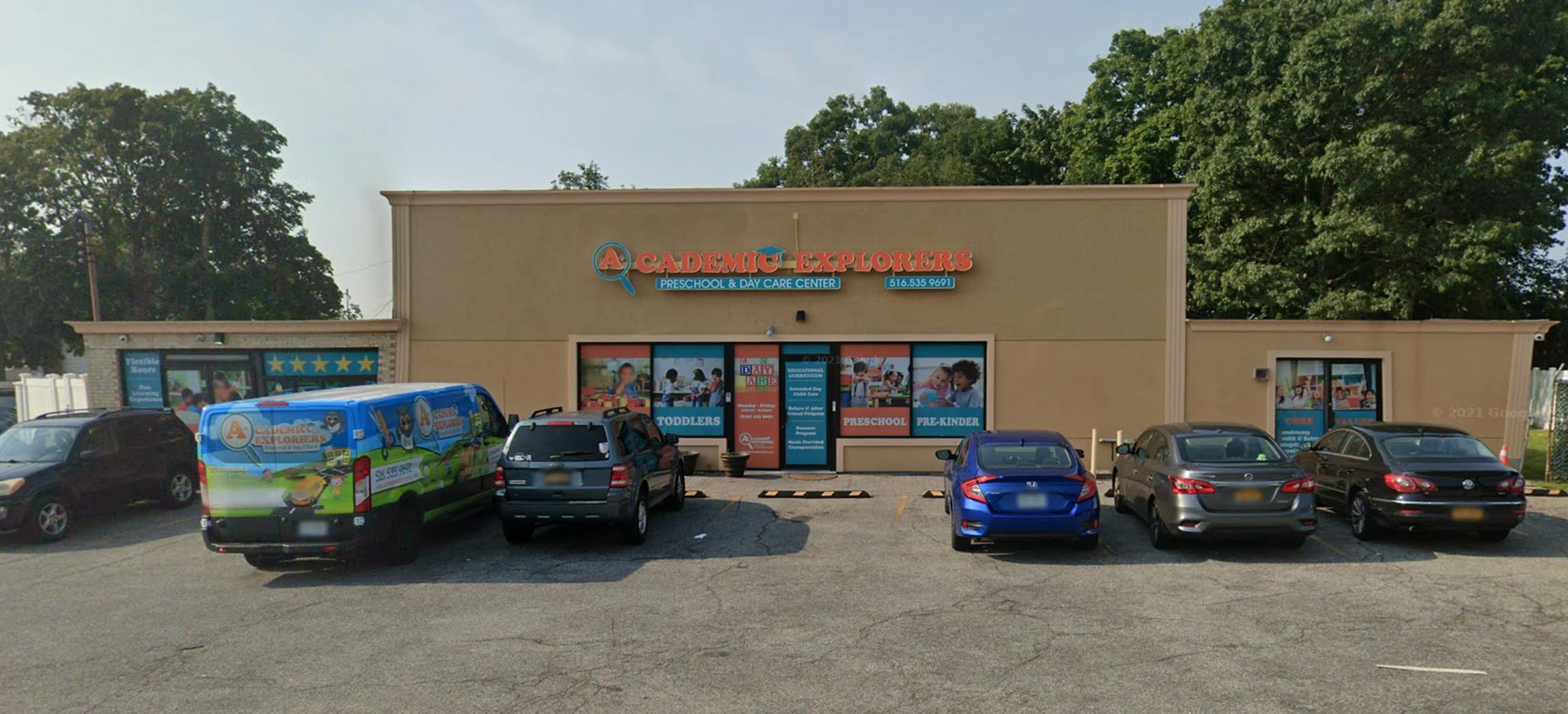 Storefront with parked cars in front