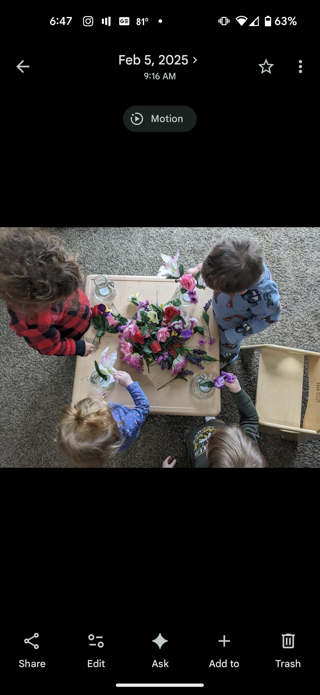 Children arranging flowers in vases at a table