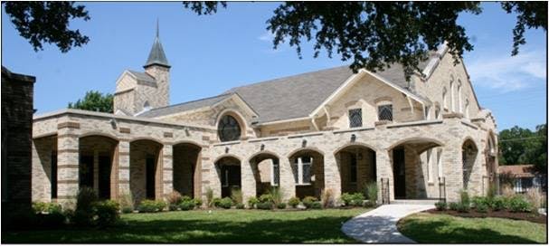 Stone building with arched walkway and steeple