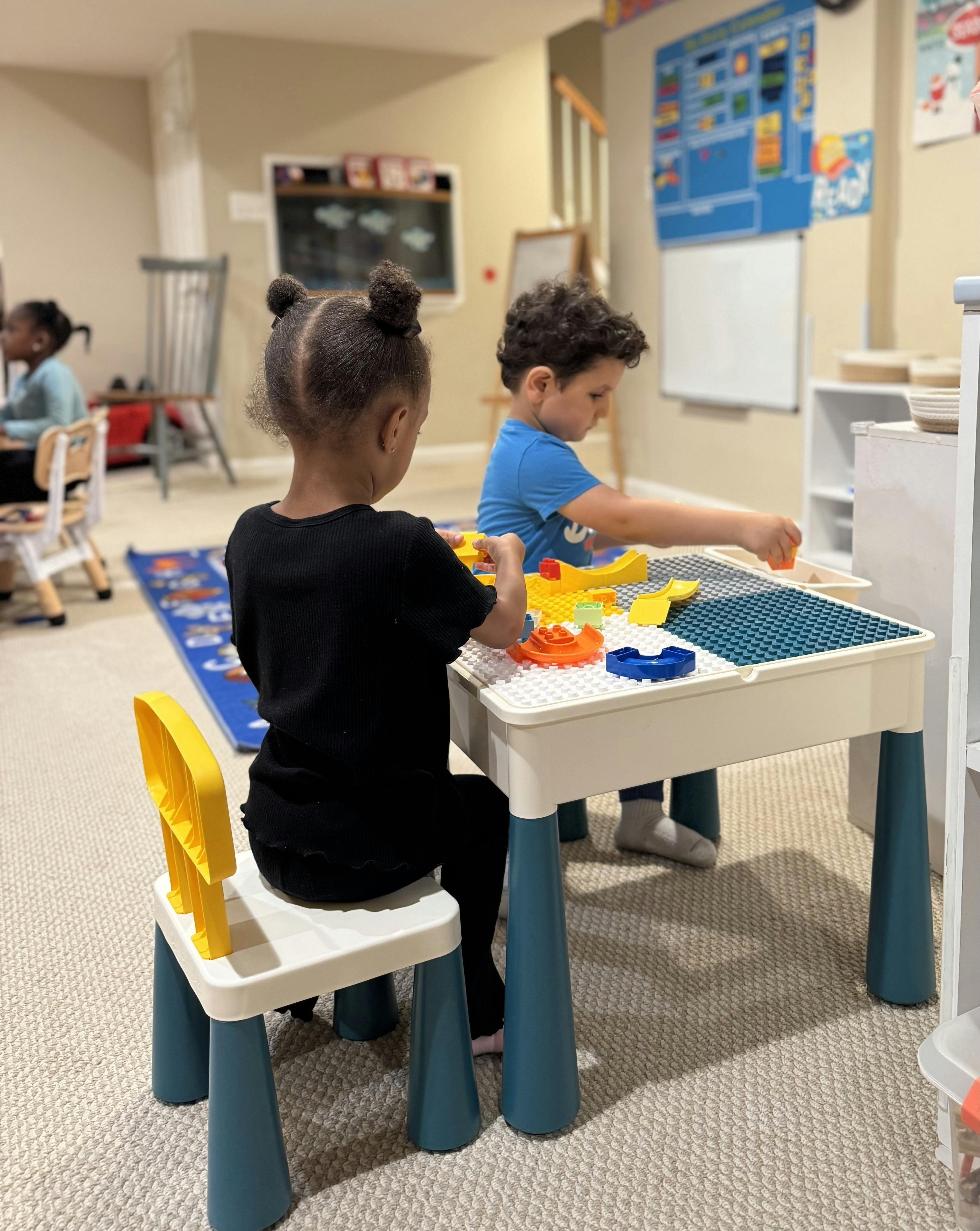 Children playing with building blocks at a table