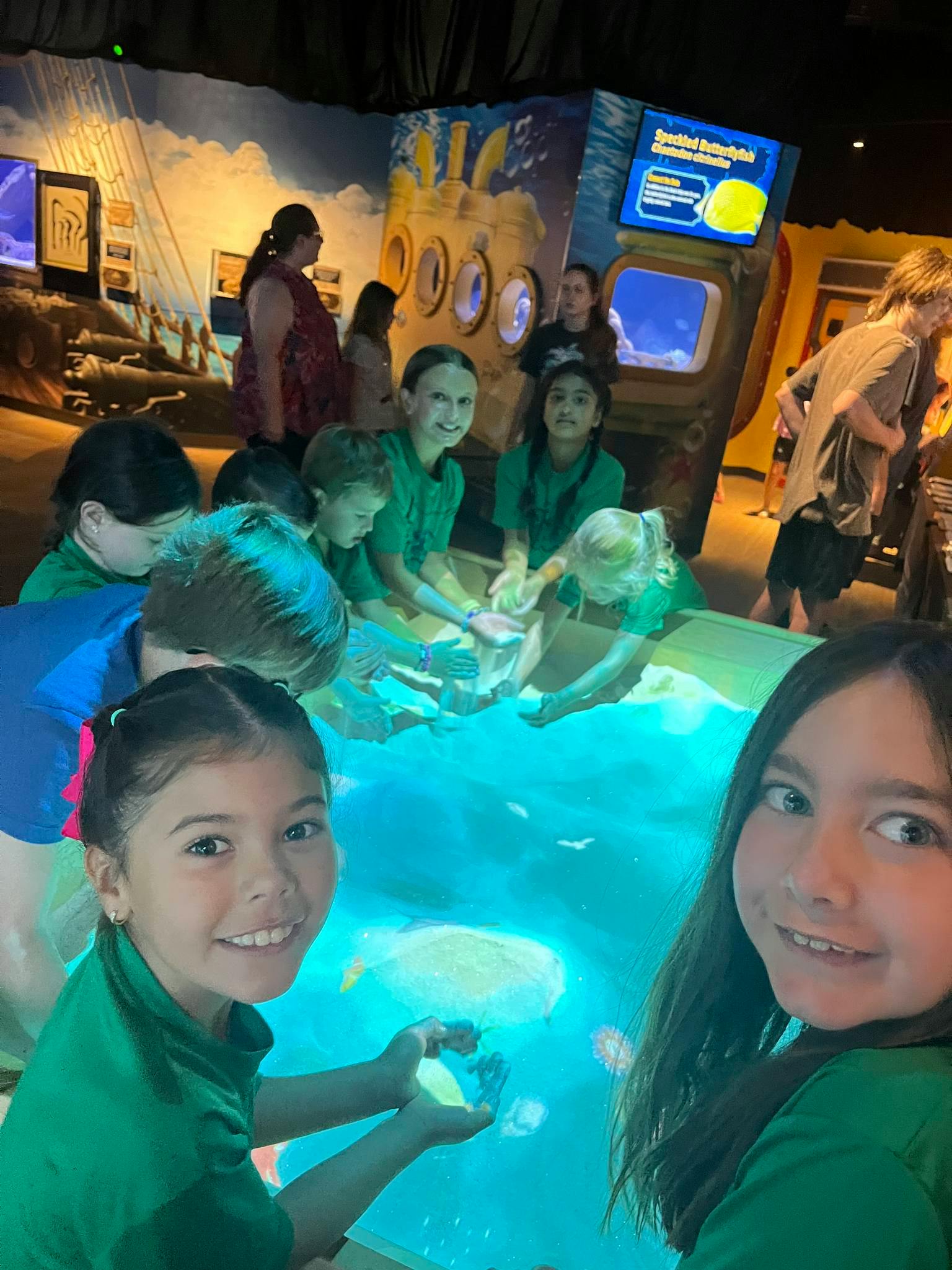 Children interacting with a water display in a dark room