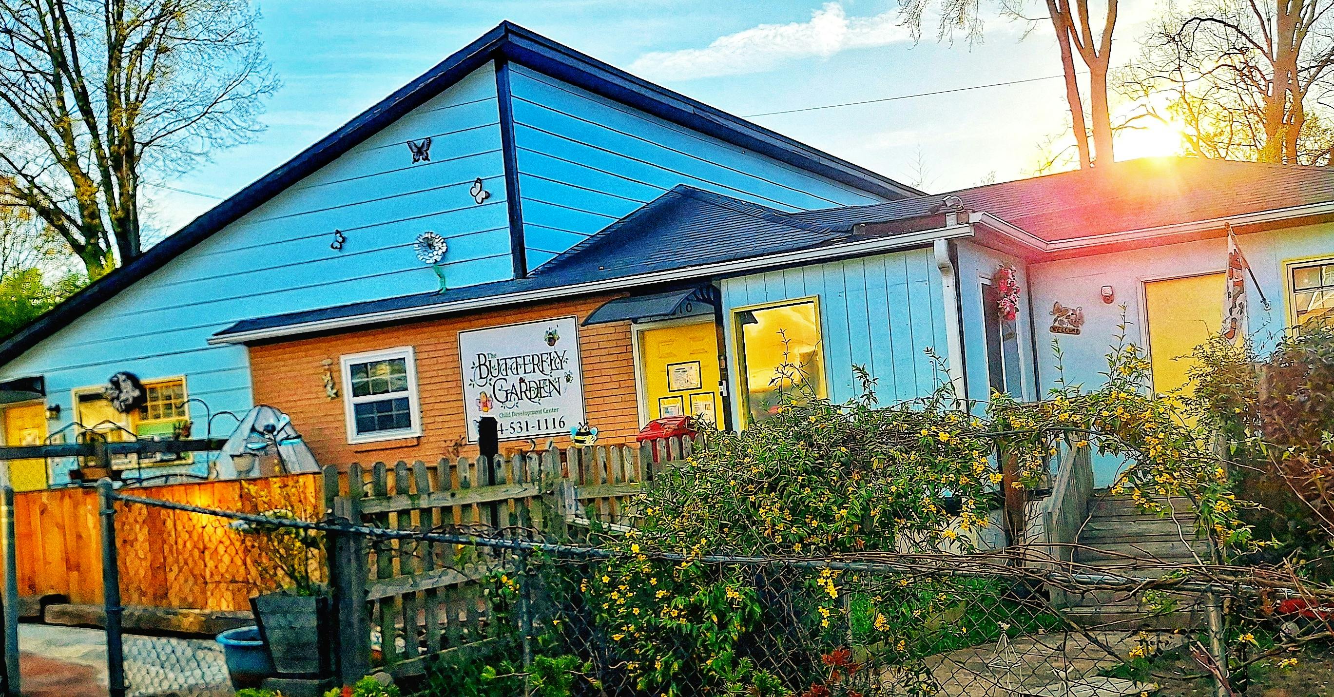A two-story building with a sign that reads, "The Butterfly Garden"