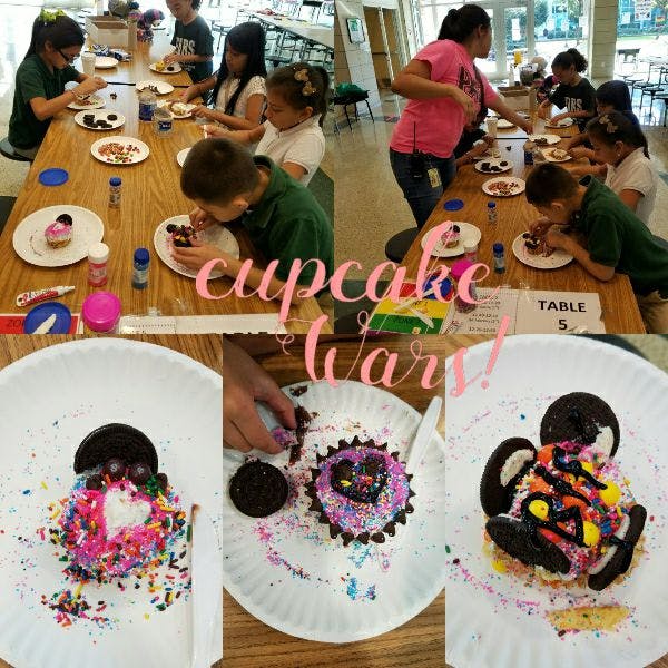 Children decorating cupcakes at a table, with finished decorated cupcakes