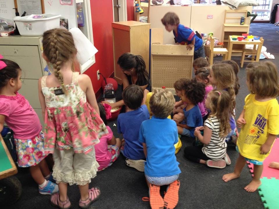 Group of children and an adult in a classroom