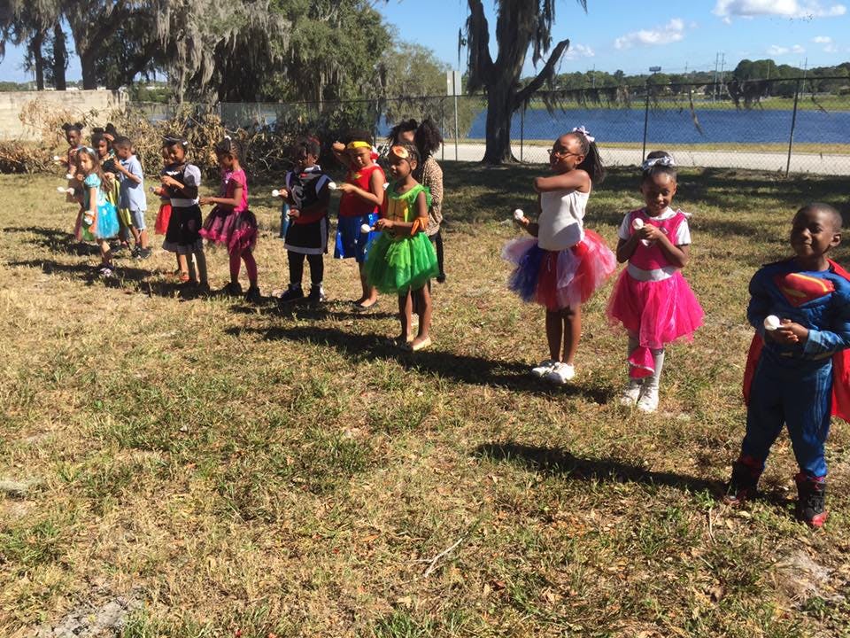 Children in costumes standing in a line outdoors