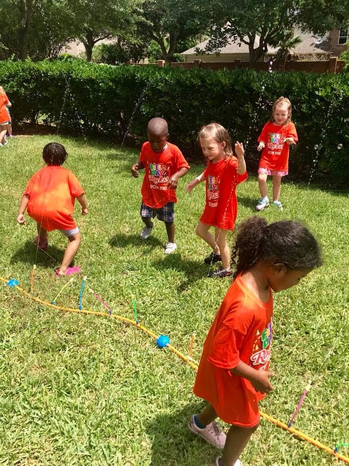 Children playing outdoors on grass