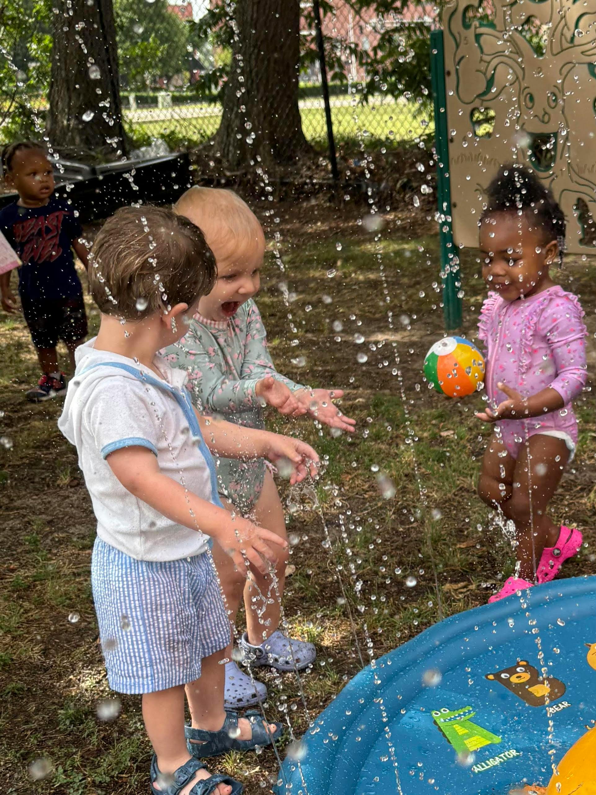Children playing in water sprays at a playground