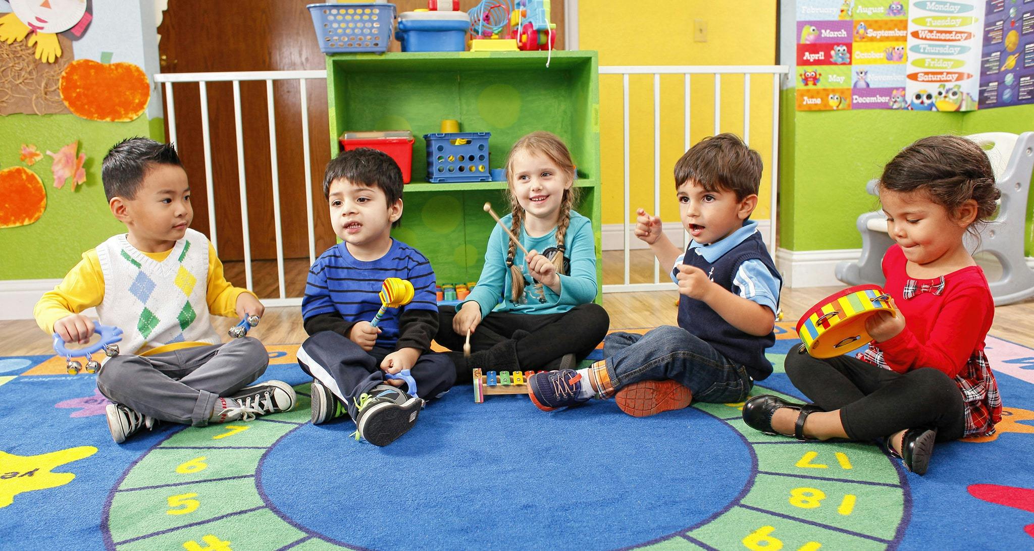 Children playing musical instruments in a classroom