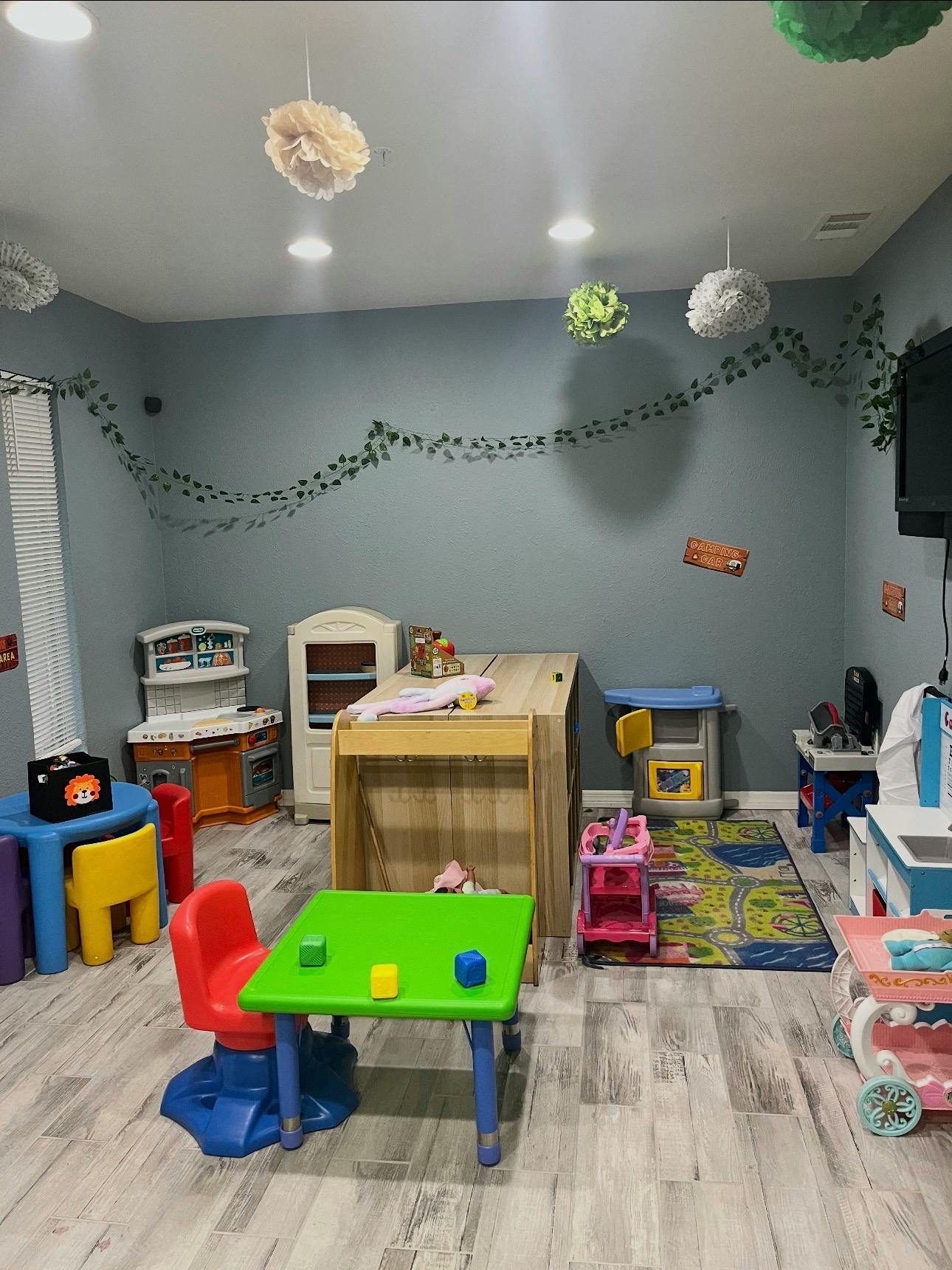 A room with various colorful child-sized play furniture and toys