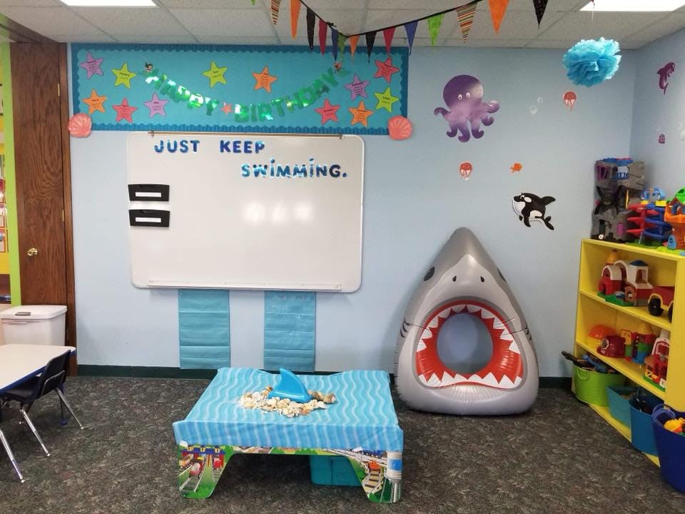 Classroom with whiteboard, shark toy, and colorful decorations