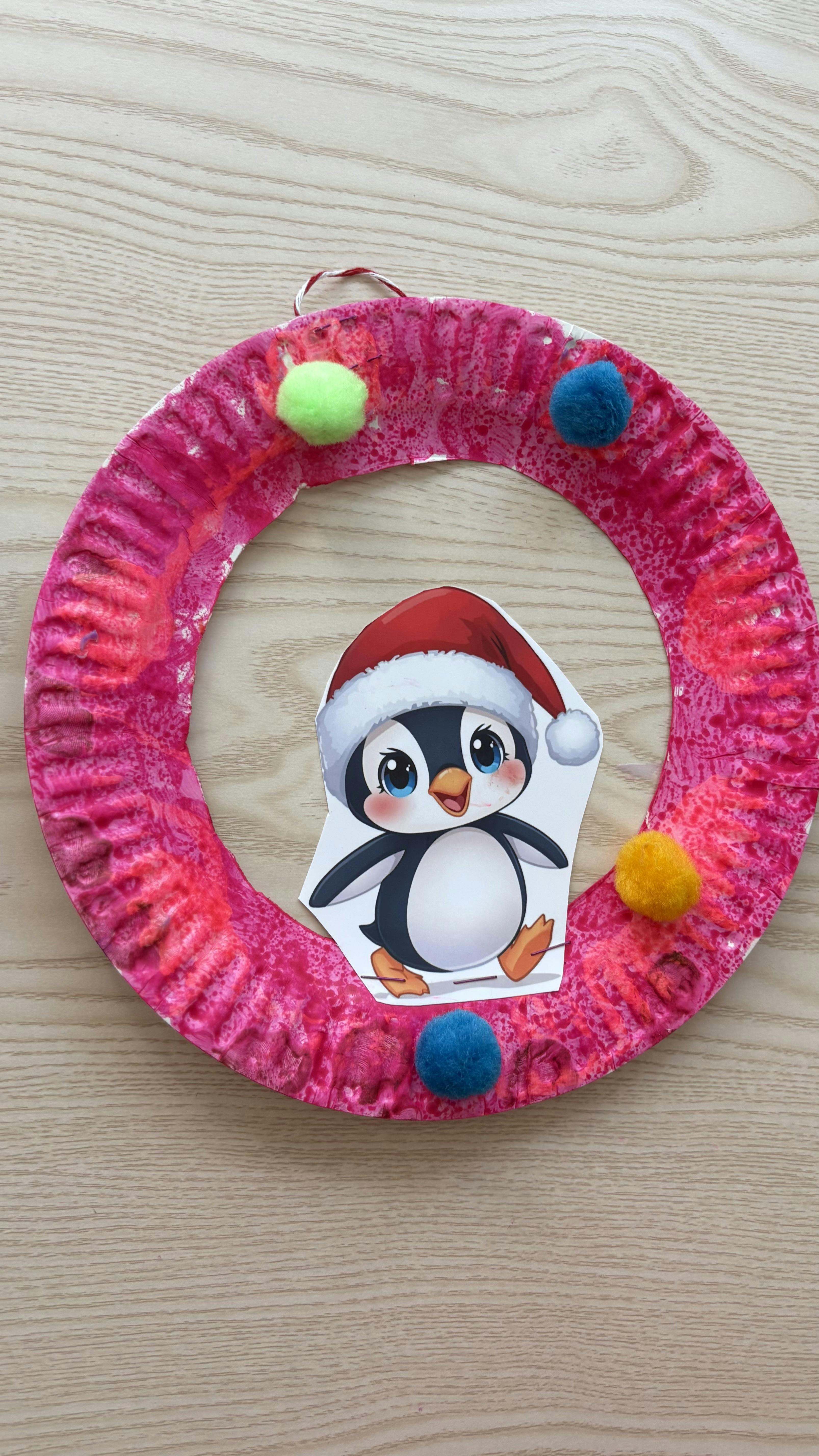 Crafted wreath with a penguin wearing a Santa hat
