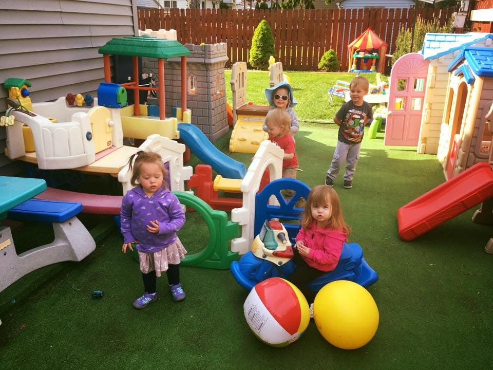 Multiple children playing on outdoor playground equipment