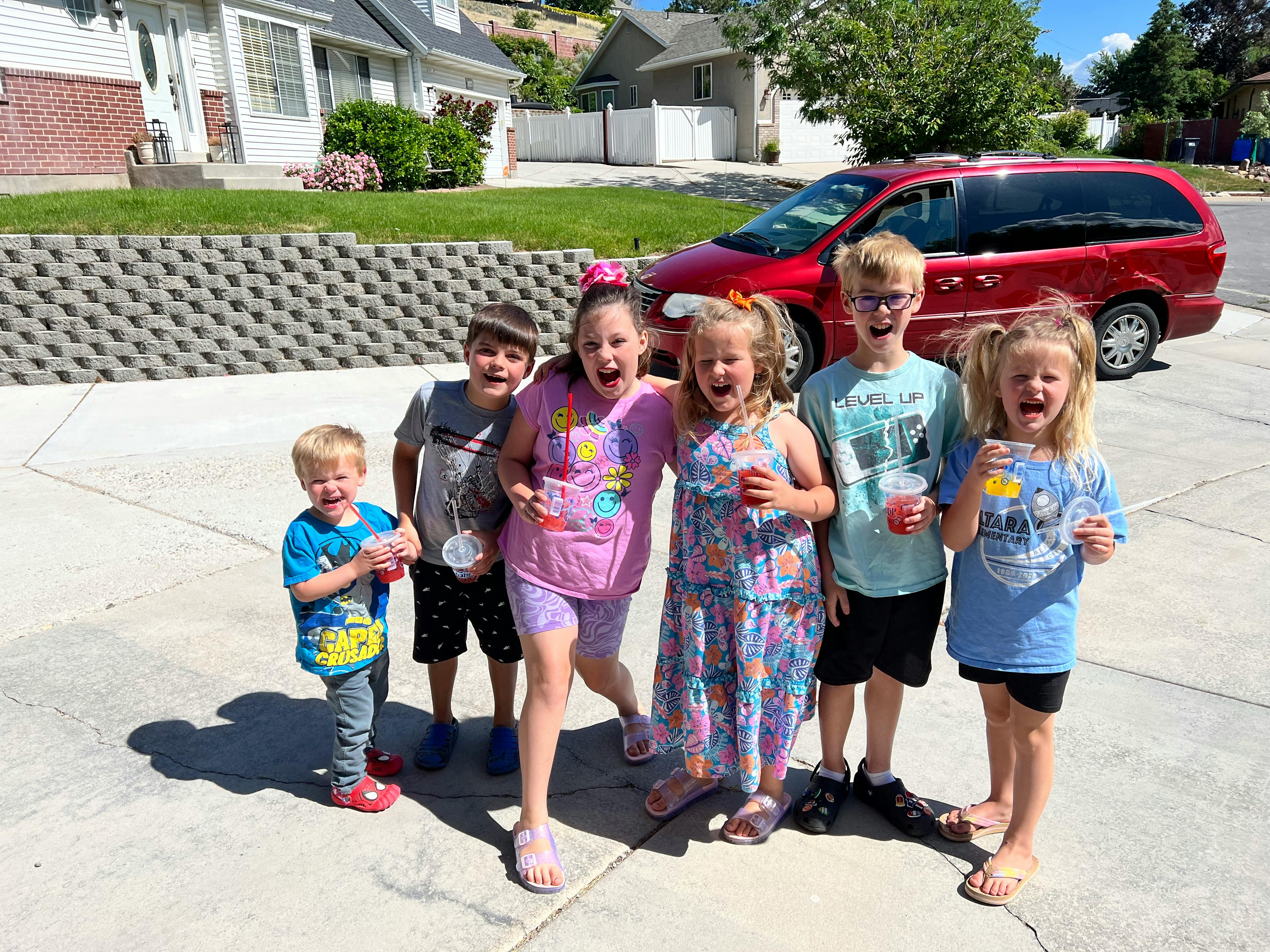 Group of children standing outside holding drinks