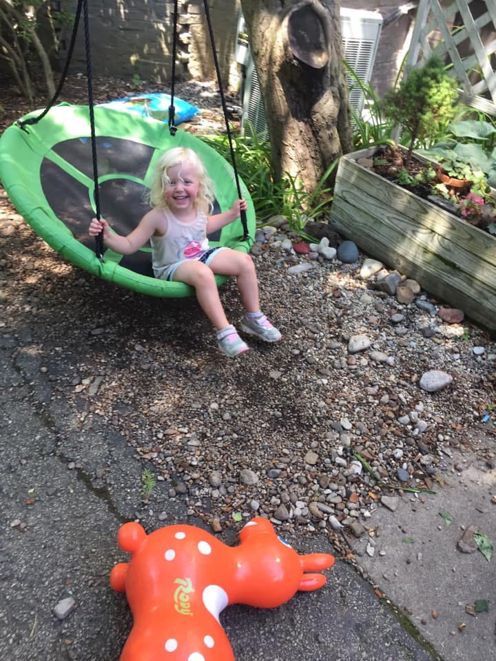 Child on a green swing