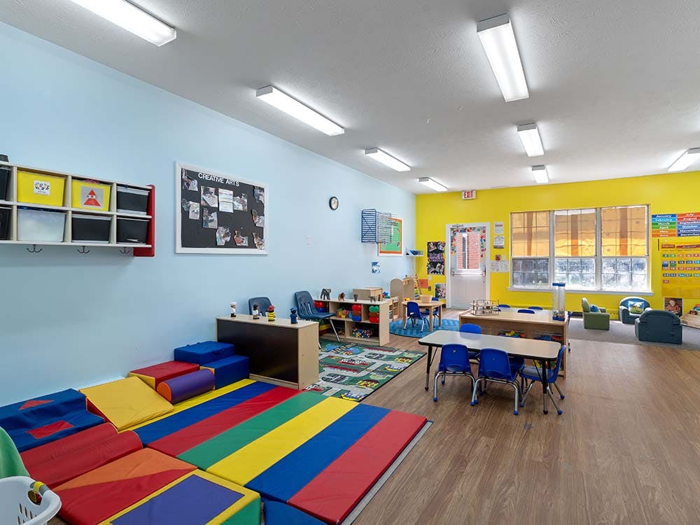 Colorful classroom with play mats and tables for young children