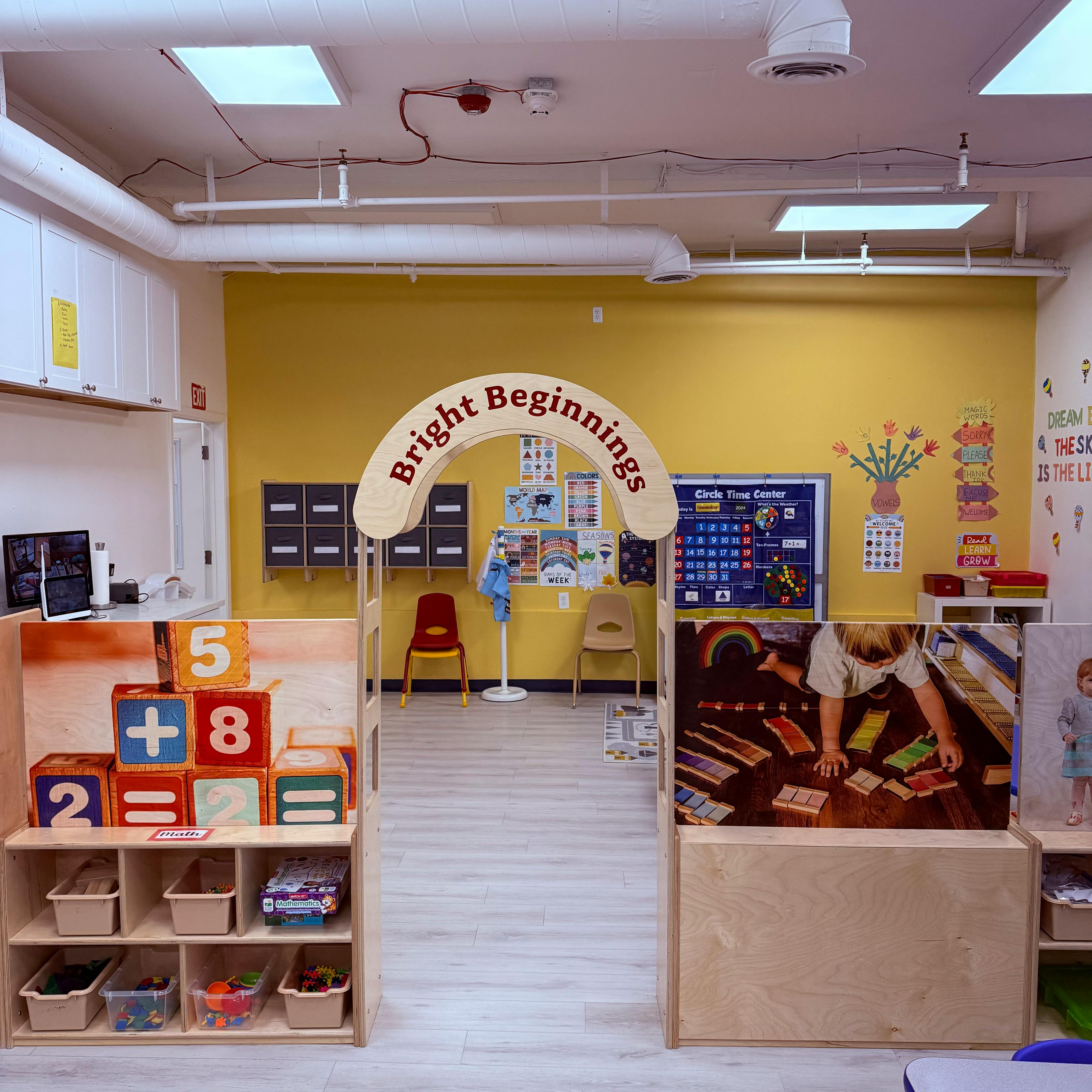 Classroom with a "Bright Beginnings" archway and shelves of learning materials