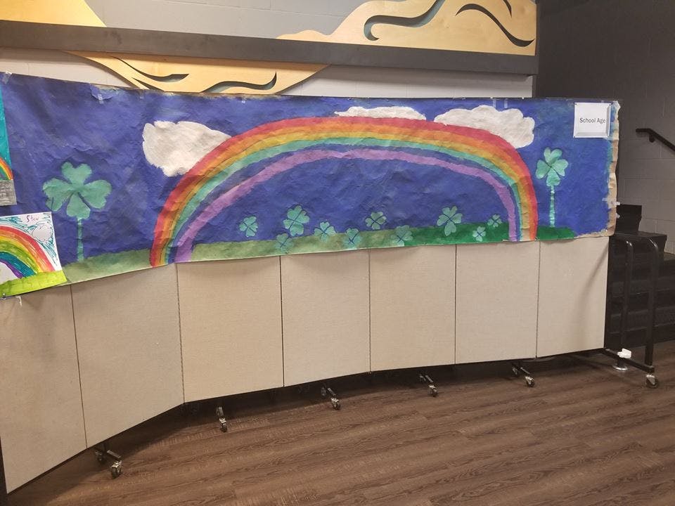 Rainbow and shamrocks painted on a blue banner