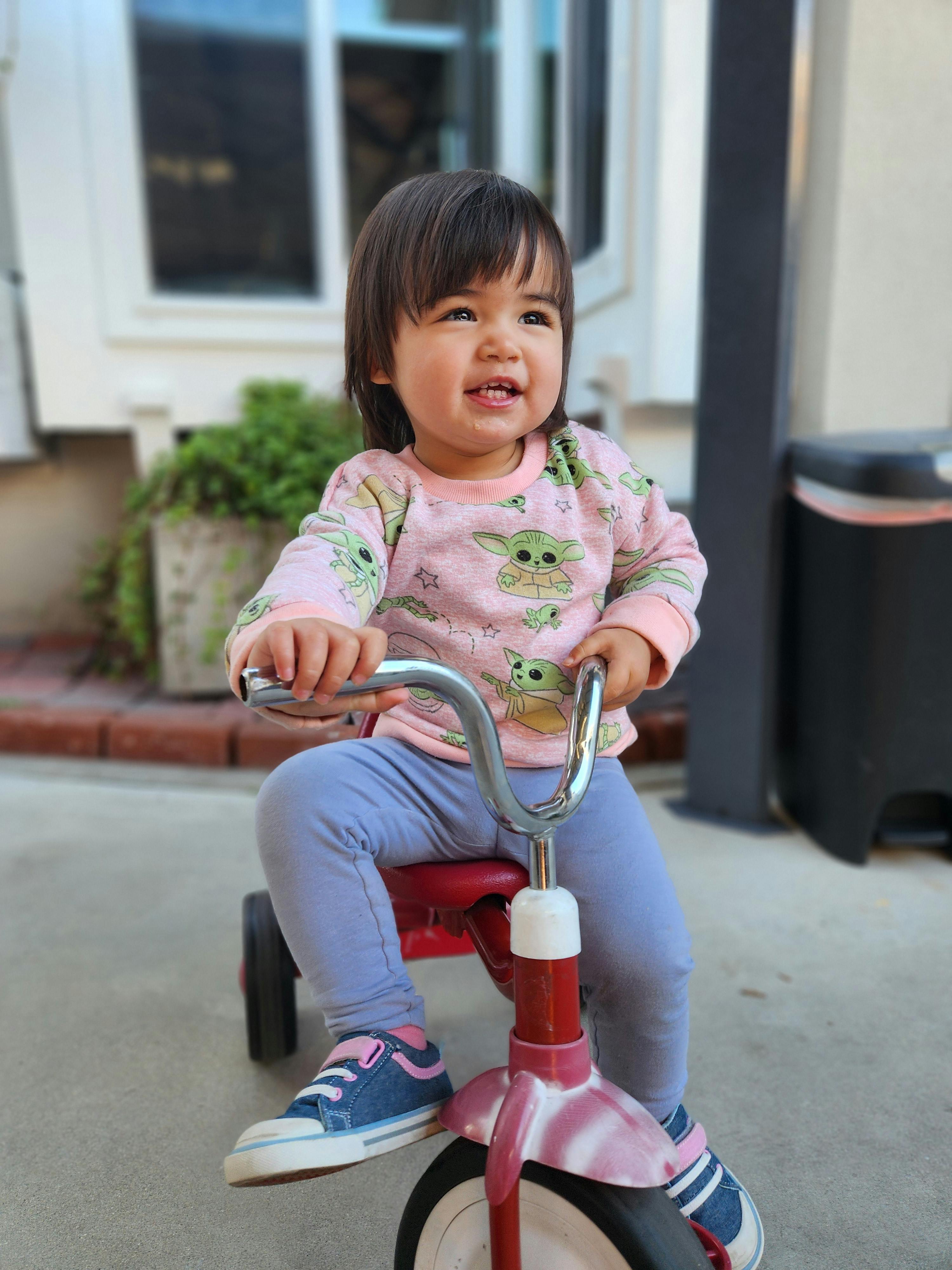 Child sitting on a tricycle